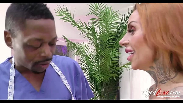 AGEDLOVE A doctor with the BBC examines a busty woman