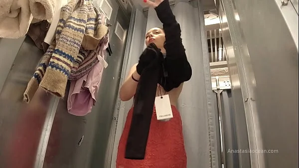 I try on clothes in fitting room with open curtain.