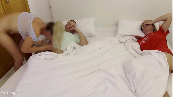 Girlfriend sneaks into swinger couple bedroom to fuck husband