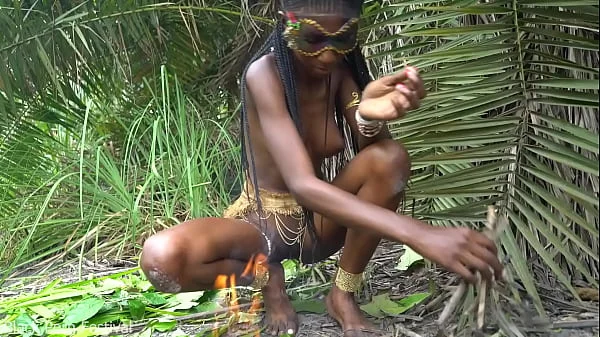 Hot African native woman cooking in the jungle