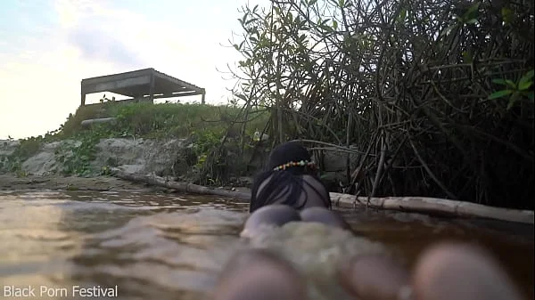 Skinny dark skinned African hottie teasing in the water