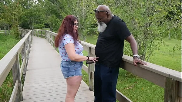 Nerdy Milf strokes and suck blk dick in the Park