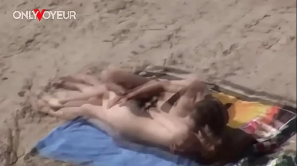 Beach Voyeur. Young nudist couple enjoying sex on the beach