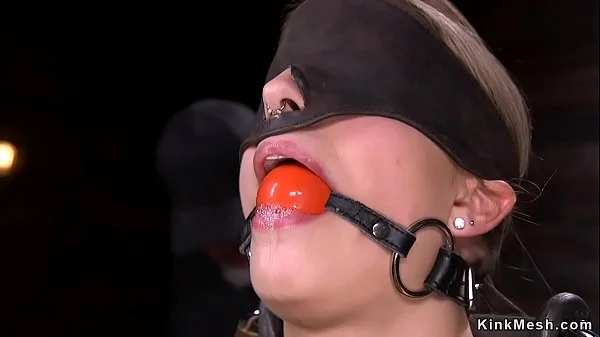 Blonde strapped in metal device bondage