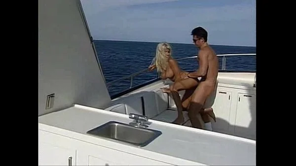 Busty lifeguard having fun on a boat.