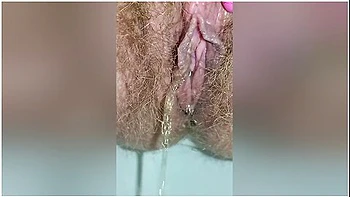 Detailed Close-up Footage Of A Hairy Pussy Girl Urinating From Her Pee Hole And Farting Loudly