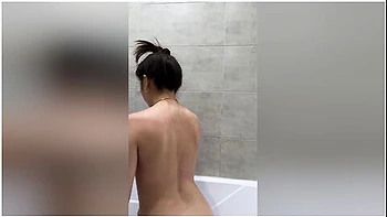Asian Woman With A Perfect Figure Takes A Shower