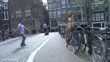 Pretty redhead walking naked in Amsterdam