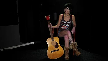 The backstage of a tattooed brunette girl, Kodi Jett, during filming