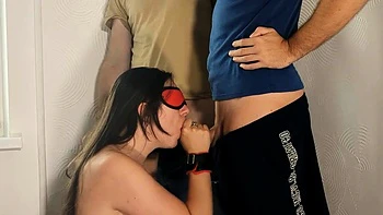 Whore Sucks Two Cocks and Swallows Cum in BDSM Threesome