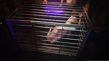 Caged redhead doll Abigaiil Morris is sucking down on the knees